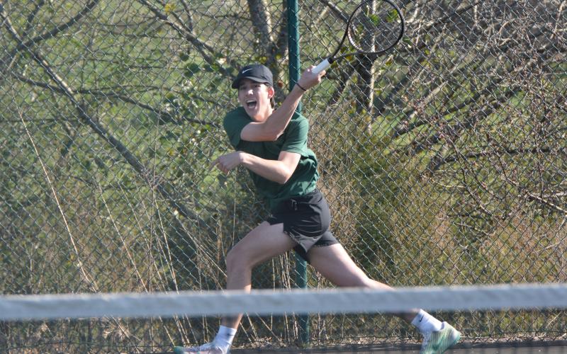 No. 1 singles player Waylon Cheek returns a ball in action Thursday against Stephens County.