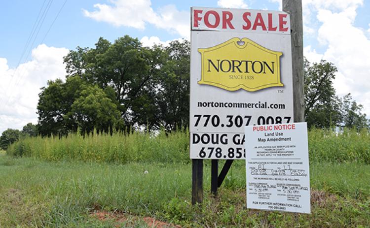 Signs posted on Old Federal Road notified the area of a rezoning request that was approved Monday for a new light industrial development.