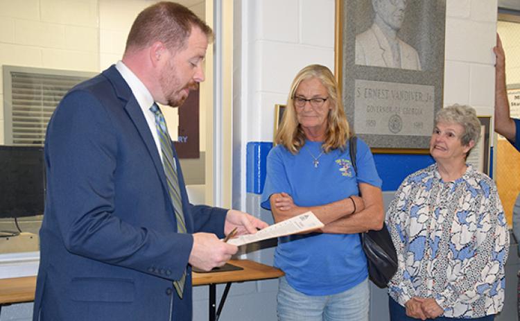 As Mayor Courtney Umbehant reads the proclamation declaring Sept. 24 Monarch Butterfly Community Awareness Day, Diane Holmes and Barbara Payne listen. (Photo by Sinclair)
