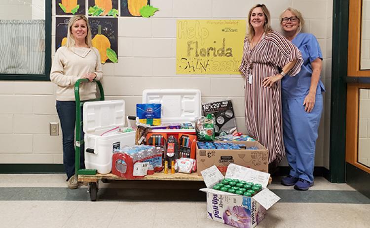 Carnesville Elementary School Assistant Principal Delina Wester, Principal Karen Correia and Nurse Norina South are proud of the community for already giving to families in Florida affected by Hurricane Ian. The donations will be driven to Myakka City, Fla., where much of South’s family lives. Donations will be taken at several locations in Franklin County through Friday before they are transported to Florida. (Photo by Sinclair)