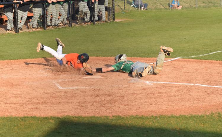 Lions catcher Will Dodd tags a Hart County runner out just before his hand reaches the plate in Region 8AAA action Thursday in Hartwell. Franklin swept a doubleheader with the Bulldogs to finish a sweep of the three-game series. (Photos by Scoggins)